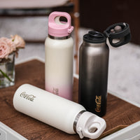 Coca-Cola-Termo Estilo Deportivo Oficial Original de Acero Inoxidable 316 Grado alimenticio Fría/caliente hermética Portátil Apertura y cierre con un solo dedo Doble función de tapa Pajita antideslizante 600ml Blanco/Negro/Rosa>200
